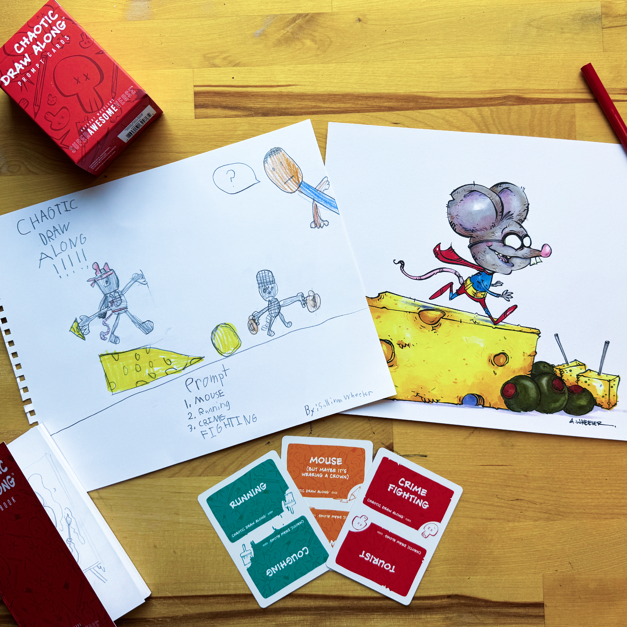 Chaotic Draw Along prompt cards beside a sketchbook drawing and finished mouse illustration on a wooden table, showing a creative drawing activity in progress.