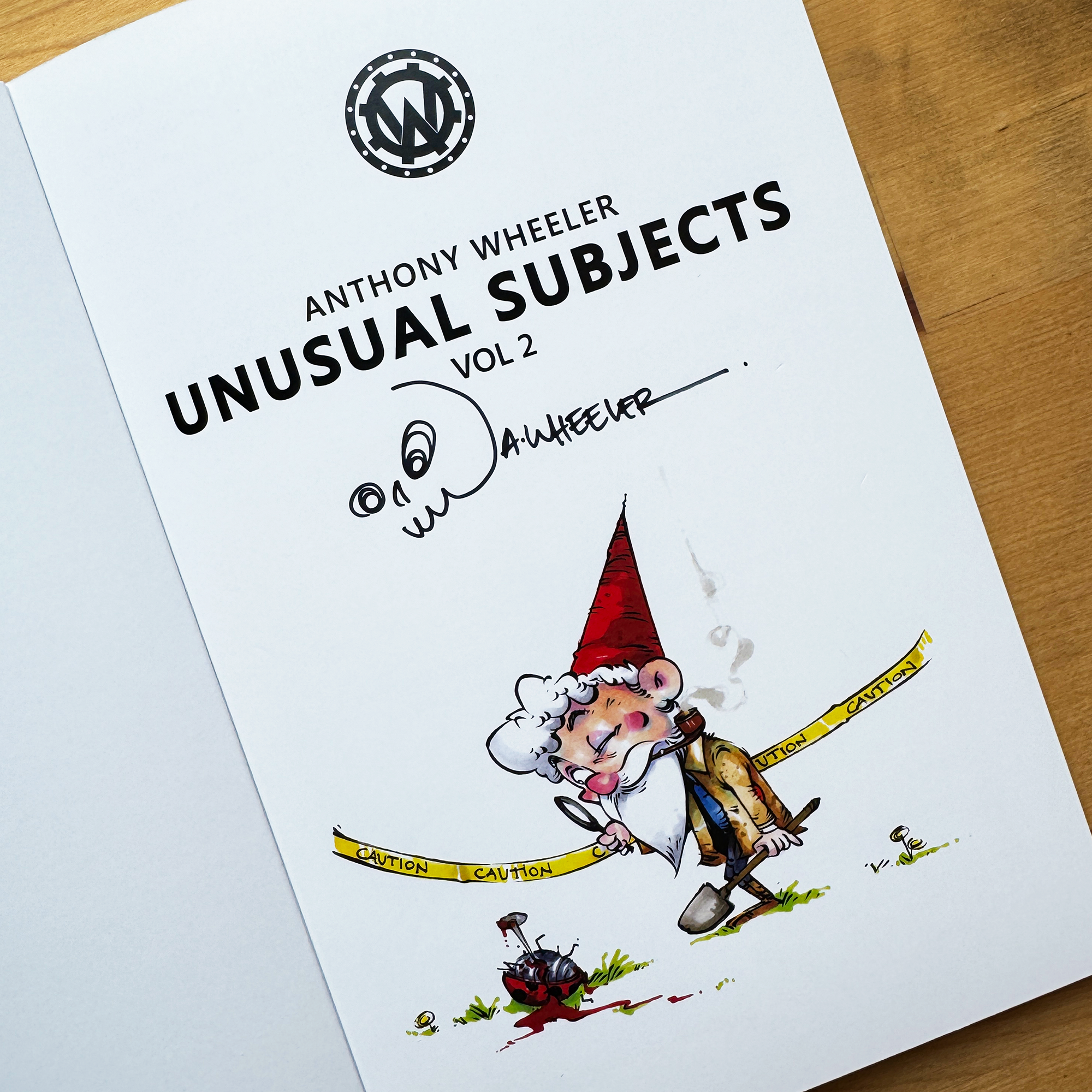 Signed Anthony Wheeler’s Unusual Subjects Vol. 2 book page with a gnome investigator illustration and skull doodle.