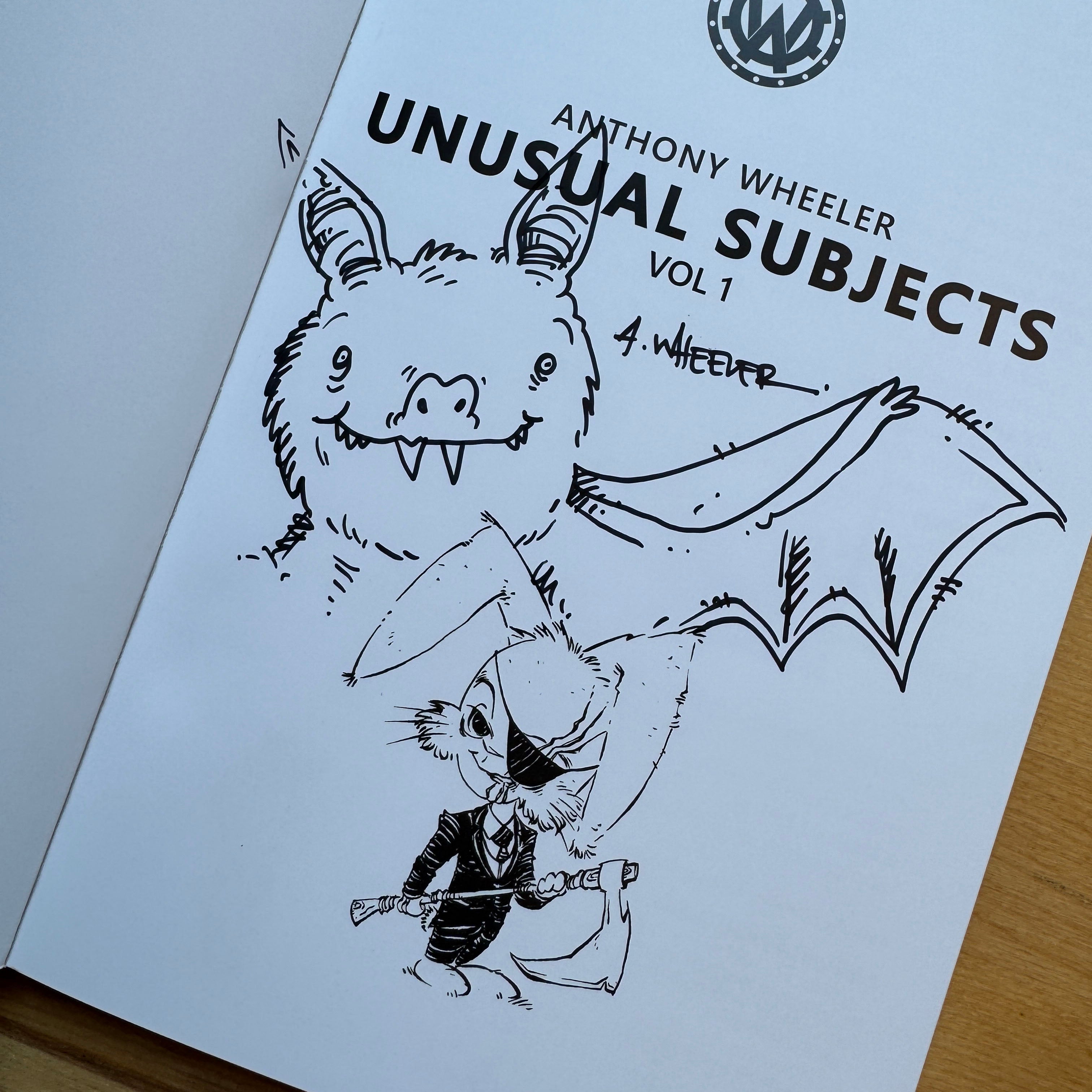 Signed doodle edition of Unusual Subjects Vol. 1 featuring an original bat illustration and Grim Reaper sketch inside the front page.
