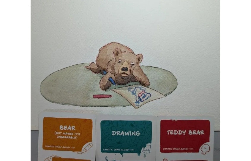 Watercolor illustration of a teddy bear lying on a rug and drawing on paper, displayed above Chaotic Draw Along prompt cards reading Bear, Drawing, and Teddy Bear.