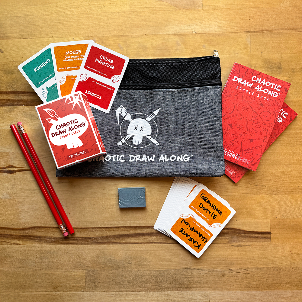 Chaotic Draw Along everything-you-need bundle with prompt cards, doodle books, booster cards, pencils, eraser, and a branded pencil case on a wooden table.