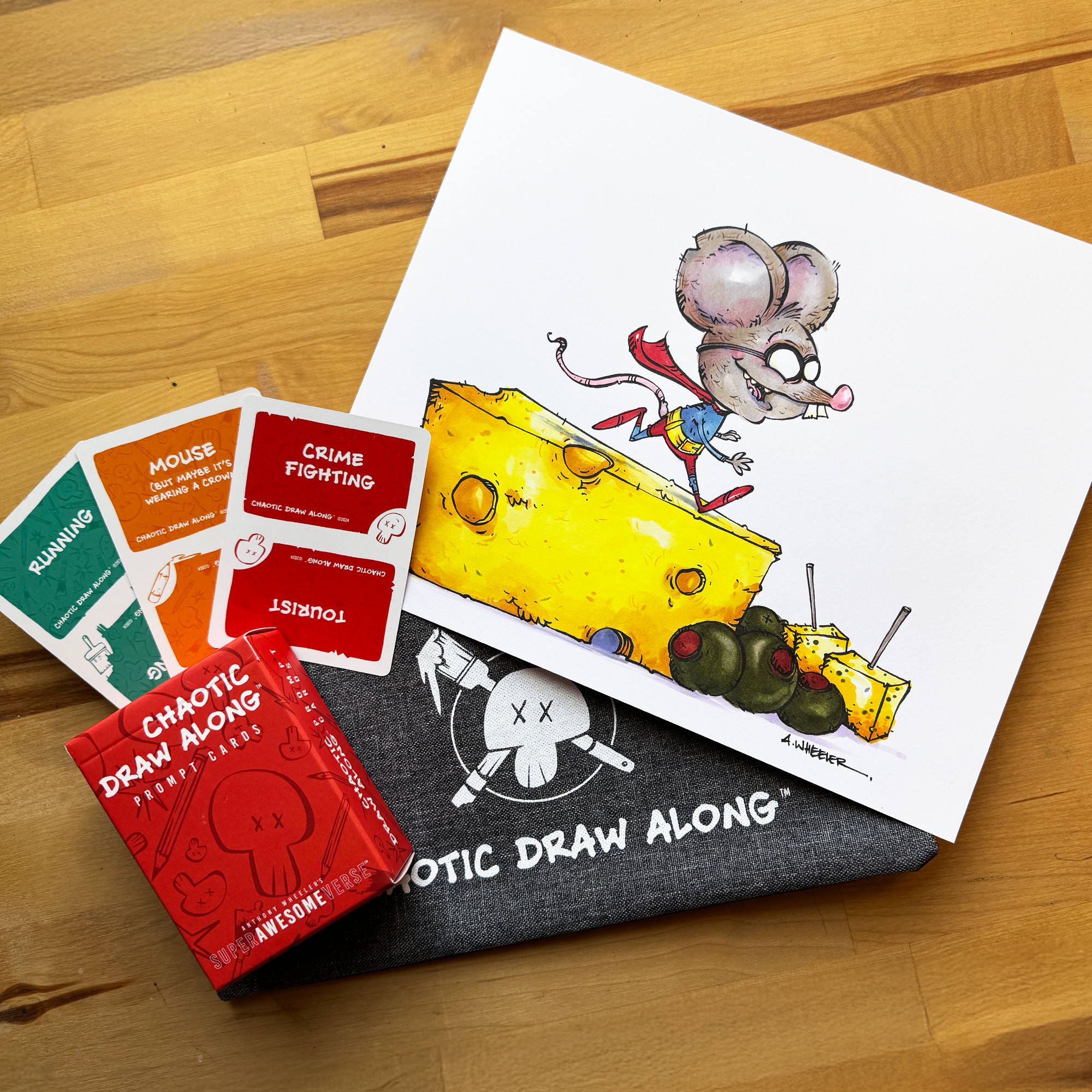 Chaotic Draw Along bundle with prompt cards, booster cards, branded pencil case, and a finished mouse illustration on a wooden table.